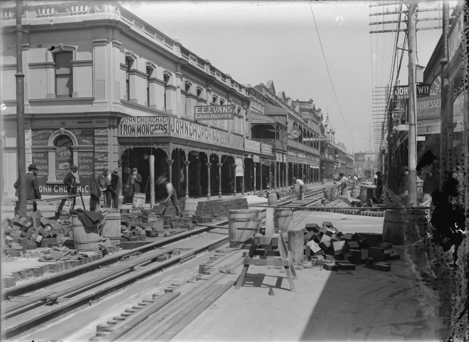Wooden blocks and equipment for sawing wood can be seen next to the tram line under construction.