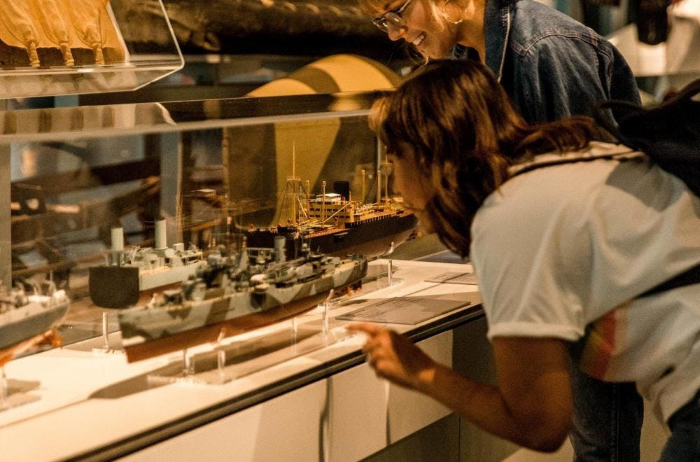 A floor display with military canoes and missiles, and a display case with many model warships form the centre of the gallery.