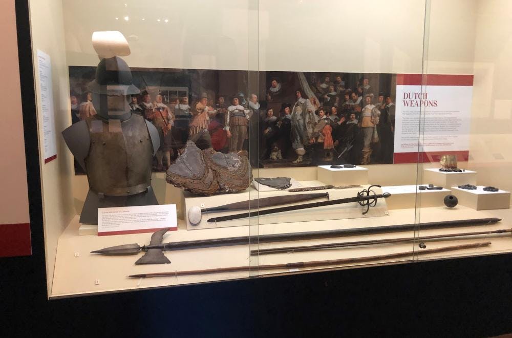 Dutch armour, helmet and weapons, displayed with Aboriginal spears and other weapons.