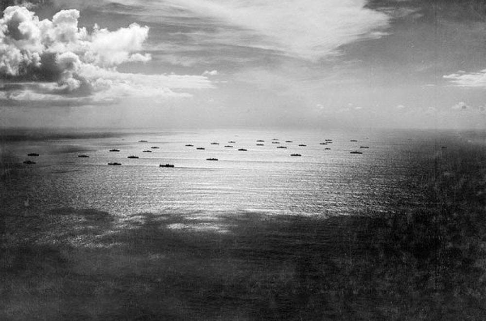Black and white image of boats on the ocean 