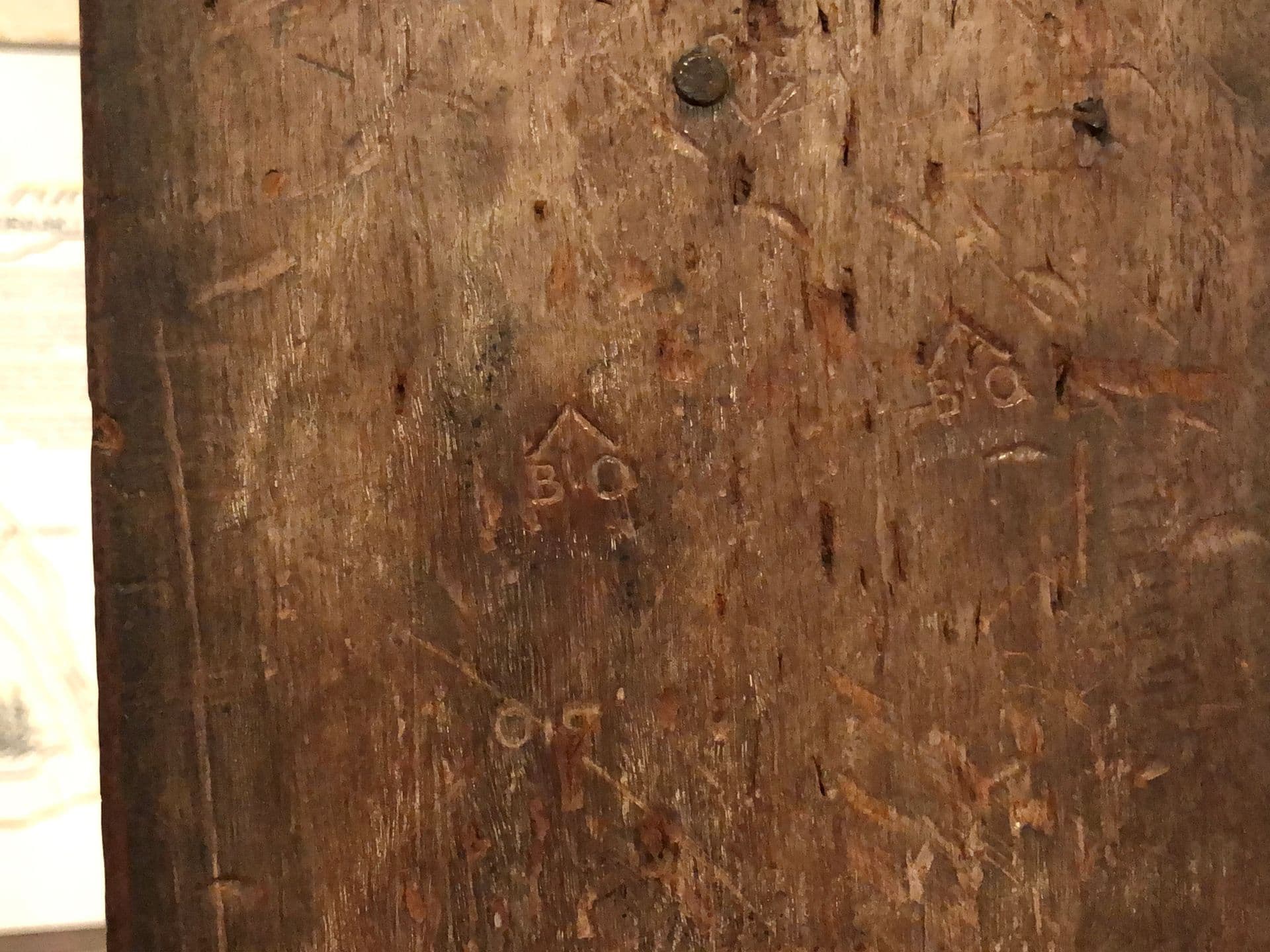 Engraved letters and arrow pointing up.