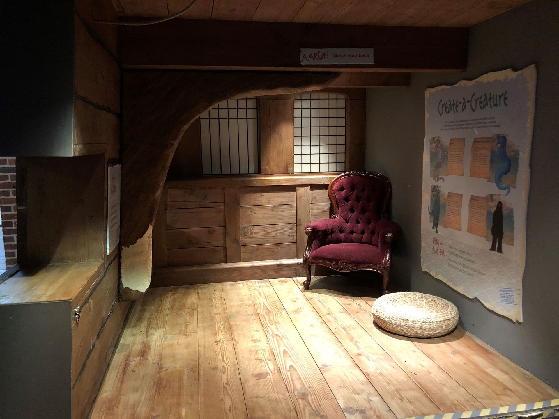 A small wooden cabin with a plush armchair in the corner.
