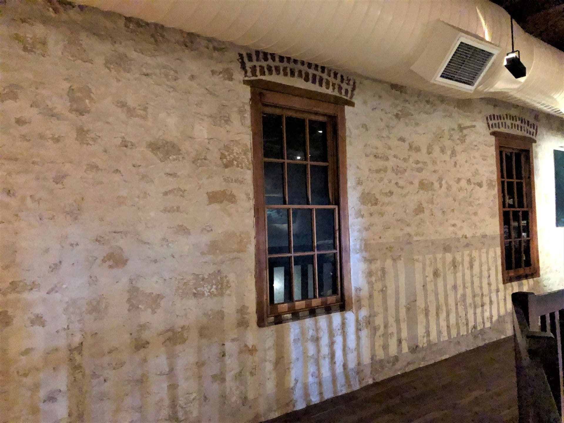 The plastered stone and wooden window frame of this room.