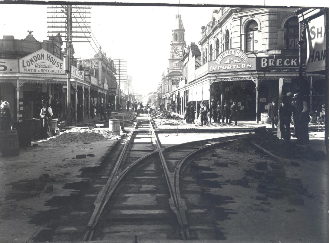 View looking down the High Street, with old buildings either side and the tram line under construction