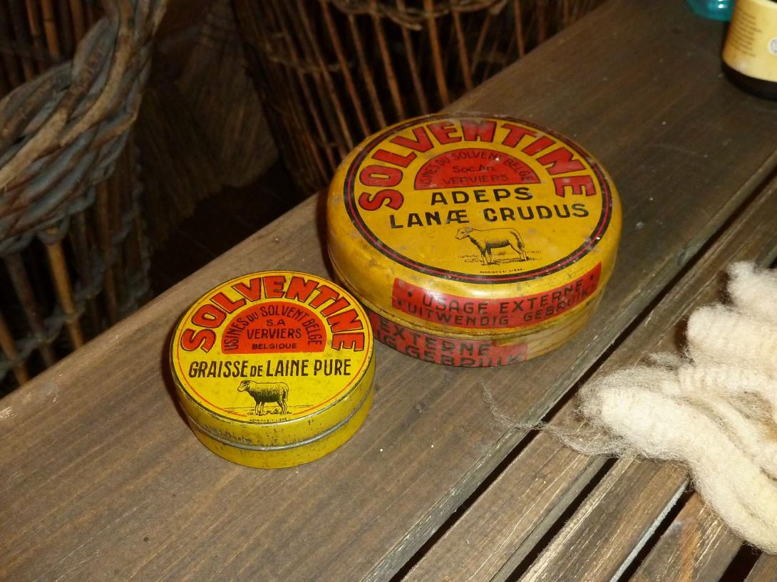 Photo of two round yellow coloured metal tins with red writing "Solventine" and other black writing, and an image of a sheep.